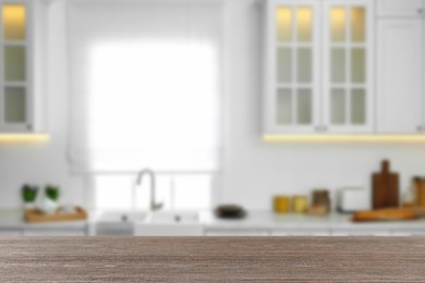 Empty wooden table and blurred view of stylish kitchen interior. Mockup for design