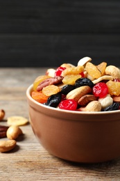Photo of Bowl with different dried fruits and nuts on table