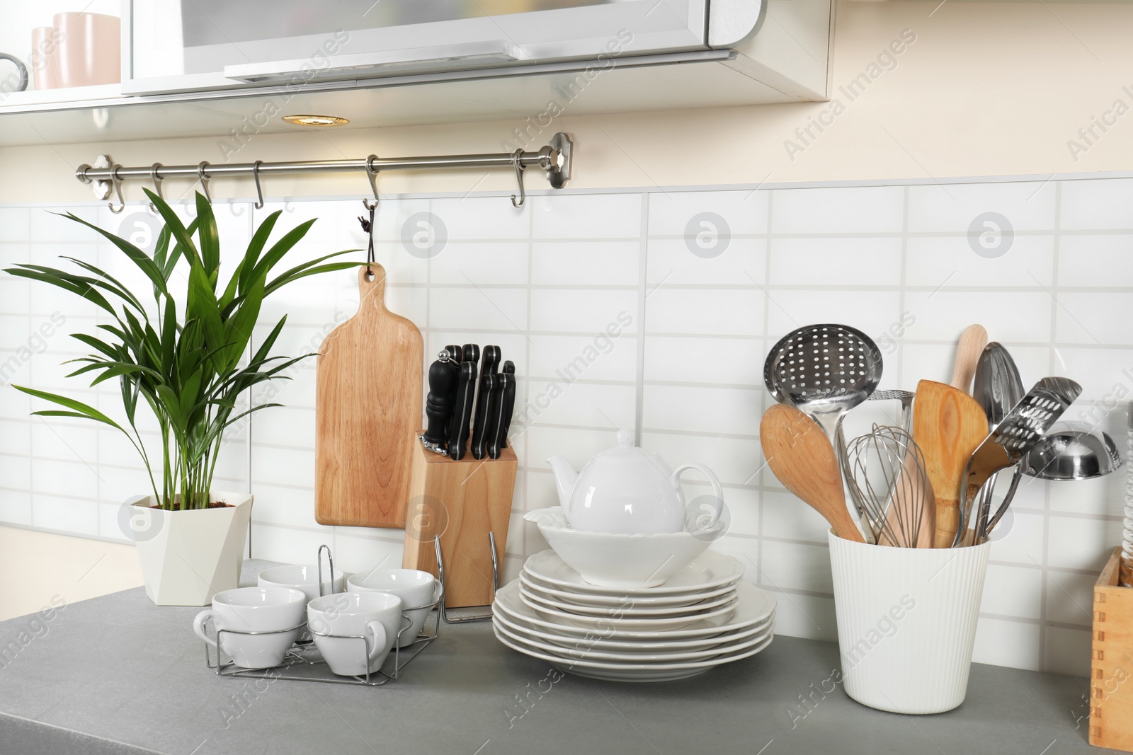 Photo of Clean dishes and utensils on kitchen counter