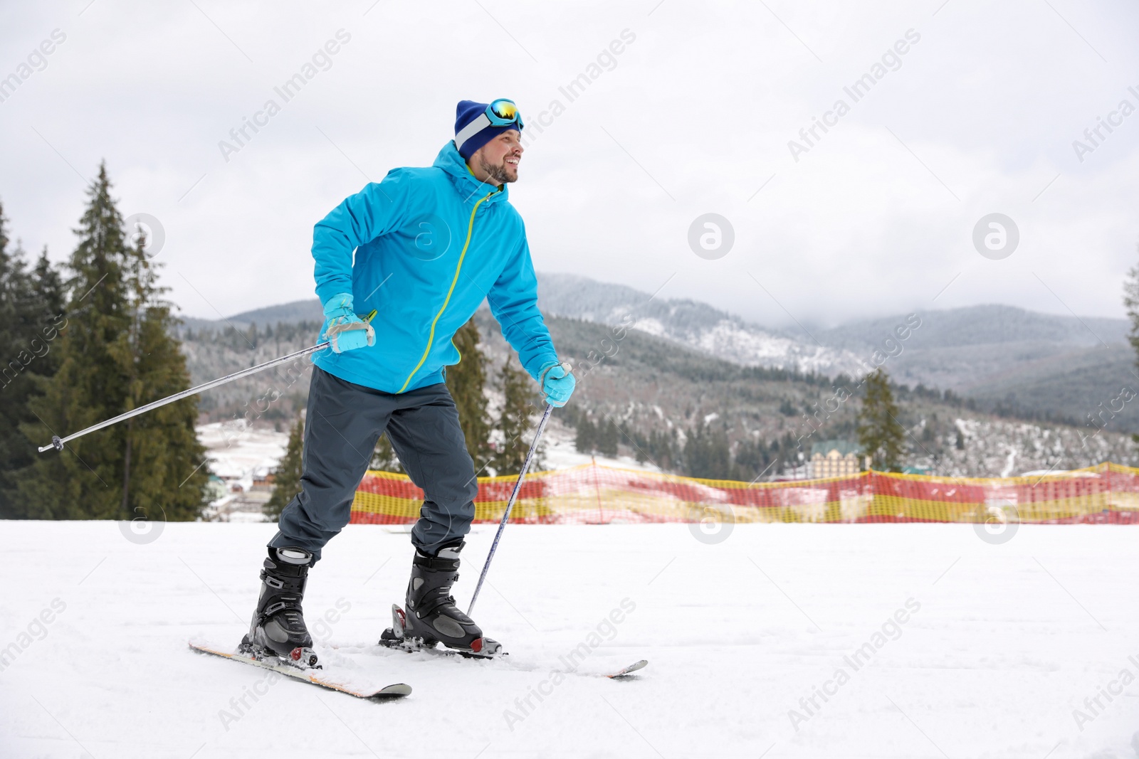 Photo of Male skier on slope at resort, space for text. Winter vacation