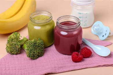 Photo of Healthy baby food, ingredients and spoon on pale pink background