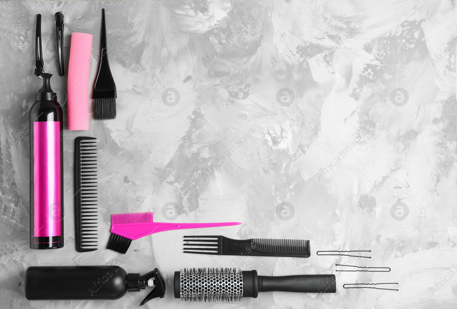 Photo of Flat lay composition with professional hairdresser tools on grey background