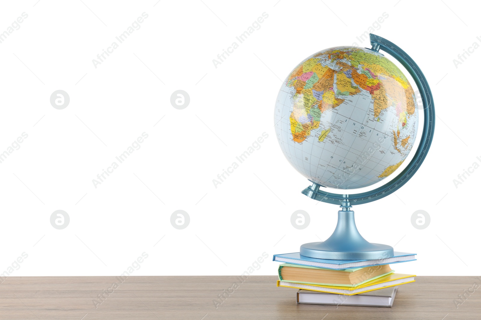 Photo of Globe and books on wooden table against white background. Geography lesson