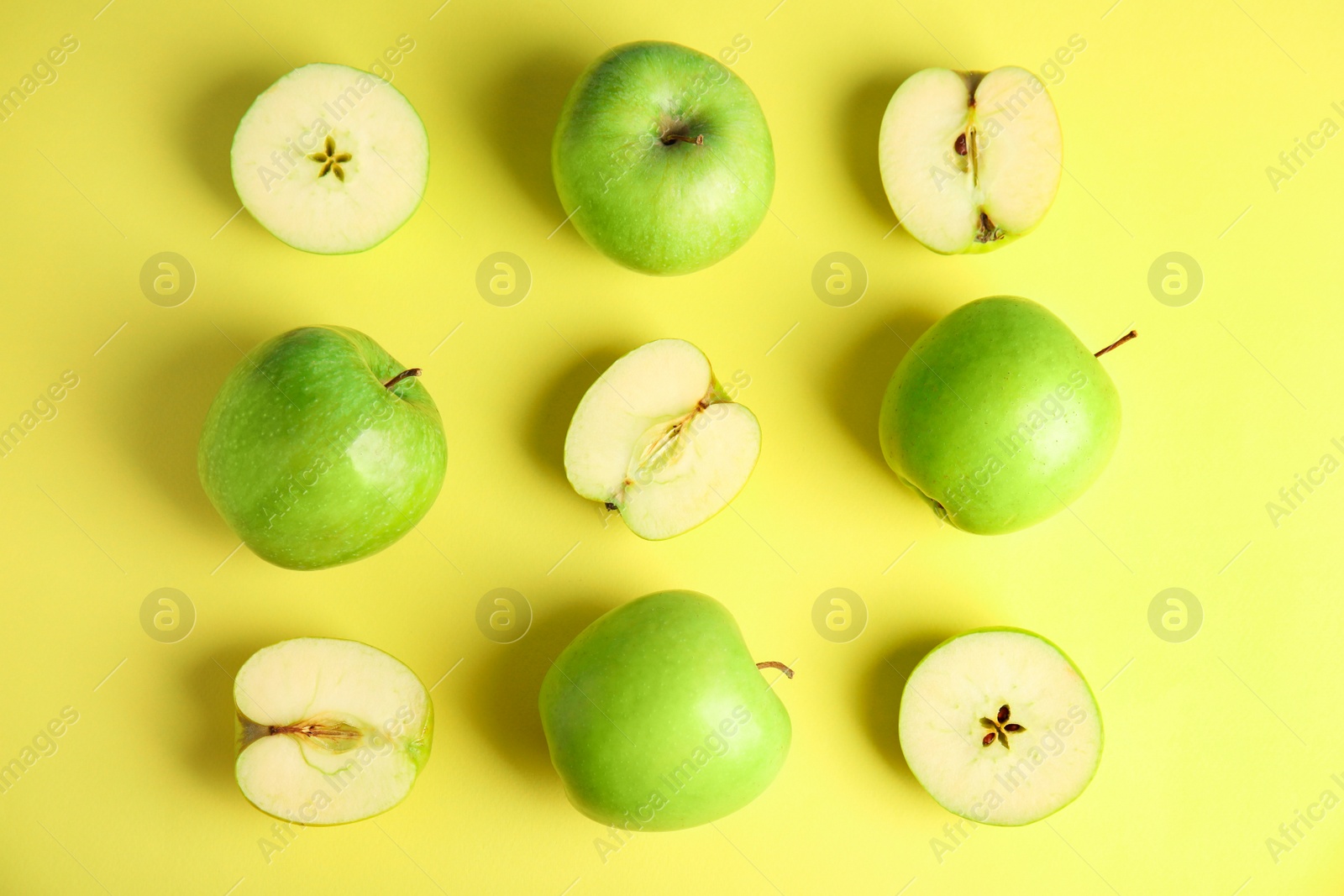 Photo of Flat lay composition of fresh ripe green apples on yellow background