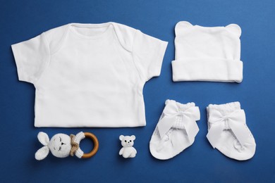 Photo of Flat lay composition with baby clothes and accessories on blue background