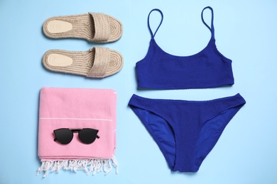Flat lay composition with bikini on light blue background
