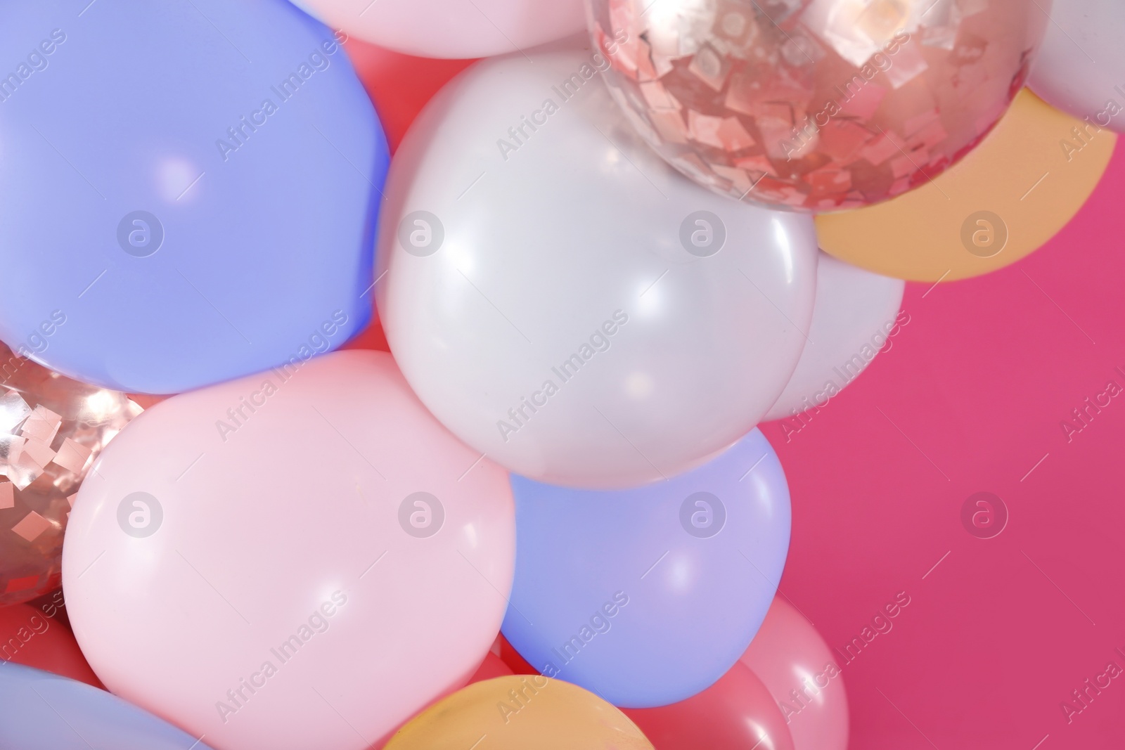 Image of Beautiful colorful balloons on pink background, closeup. Party decor 