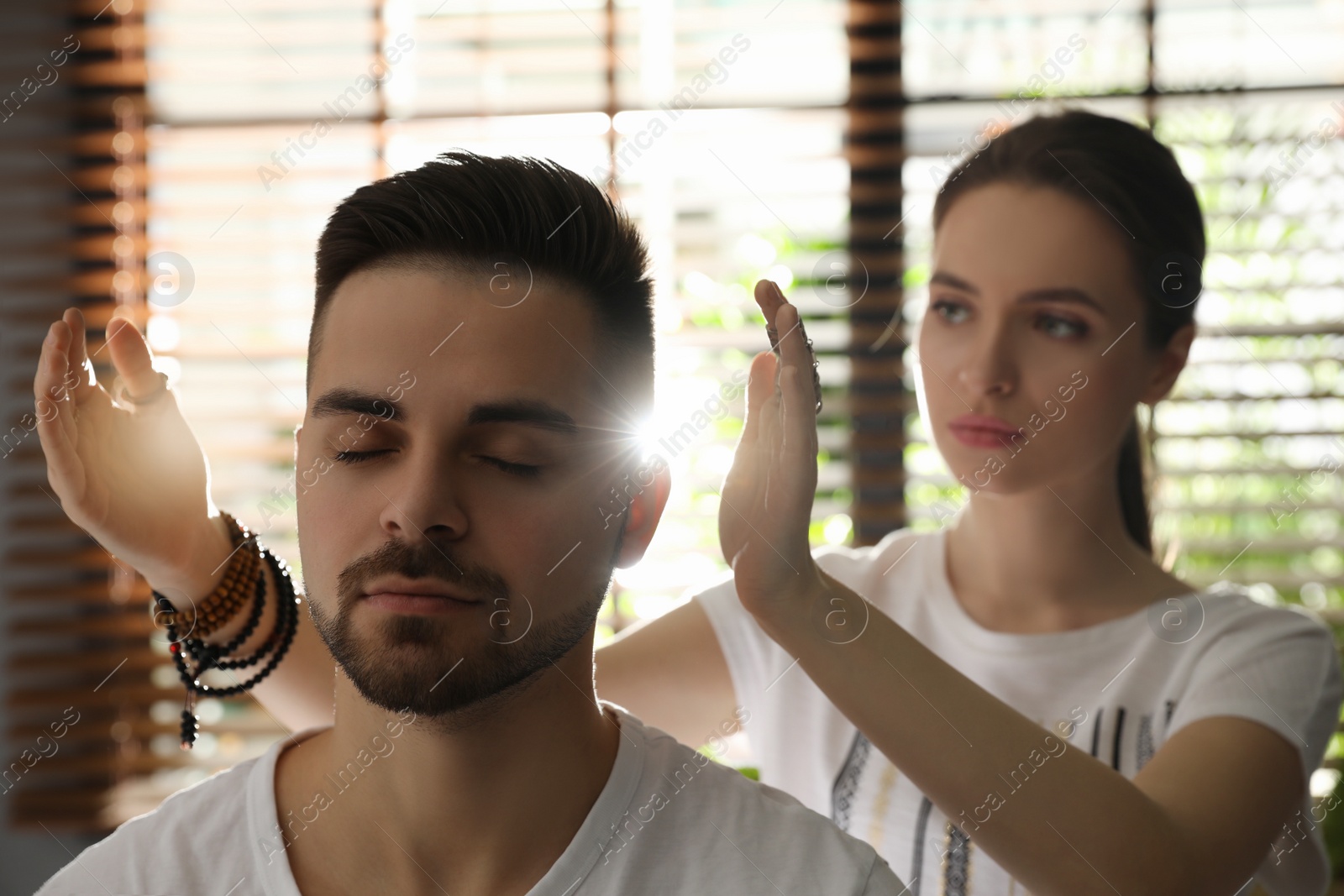 Photo of Young man during healing session in therapy room