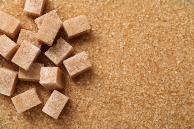 Photo of Different types of brown sugar as background, top view. Space for text