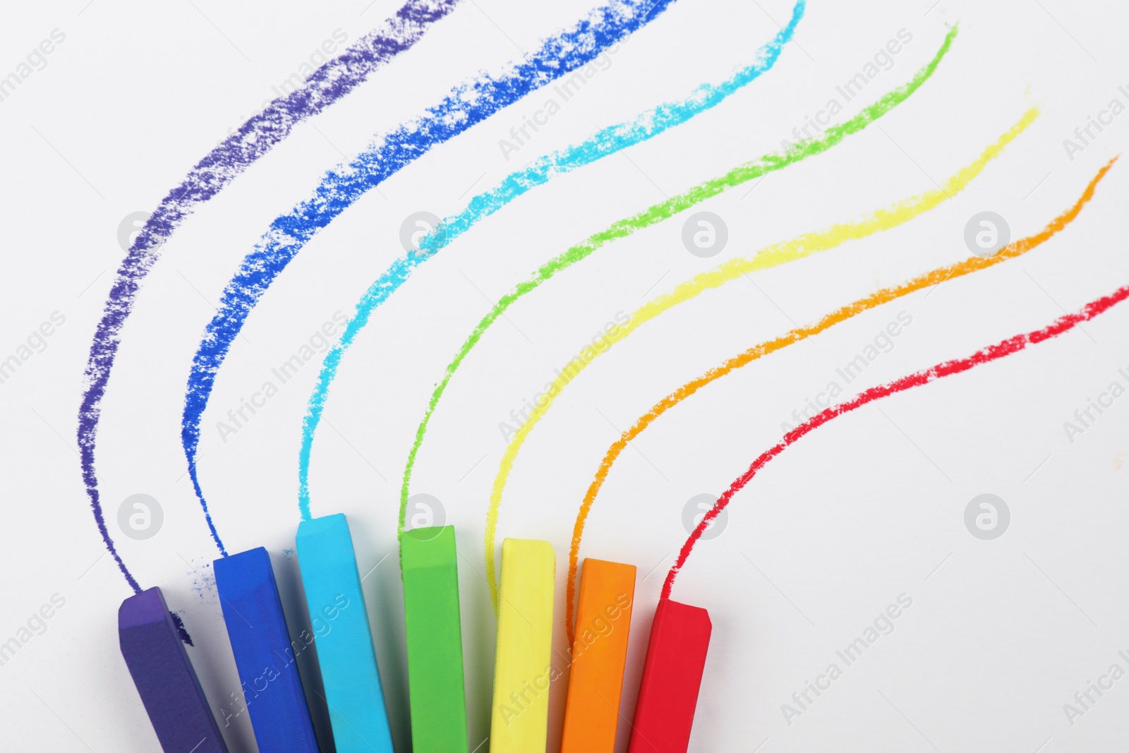 Photo of Colorful pastel chalks and lines on white background, flat lay. Drawing materials