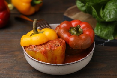 Photo of Delicious stuffed bell peppers served on wooden table