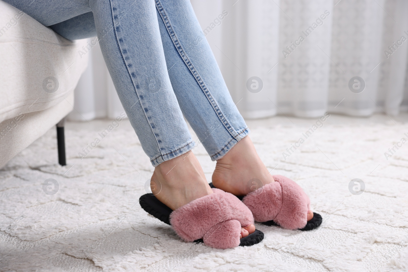 Photo of Woman in soft slippers at home, closeup