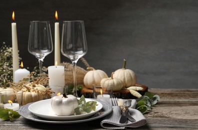 Photo of Beautiful autumn place setting and decor on wooden table, space for text