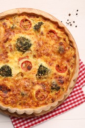 Delicious homemade vegetable quiche on white table, top view