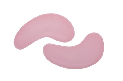 Pink under eye patches on white background, top view. Cosmetic product