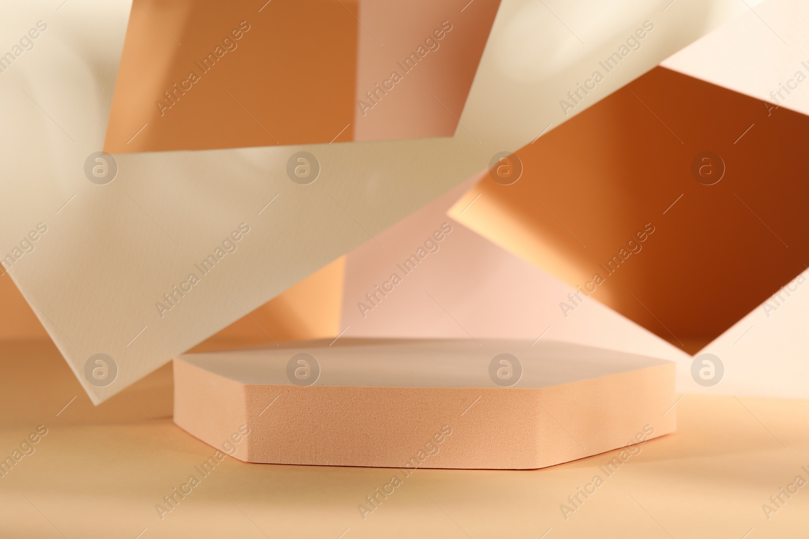 Photo of Presentation of product. Podium and paper on orange background