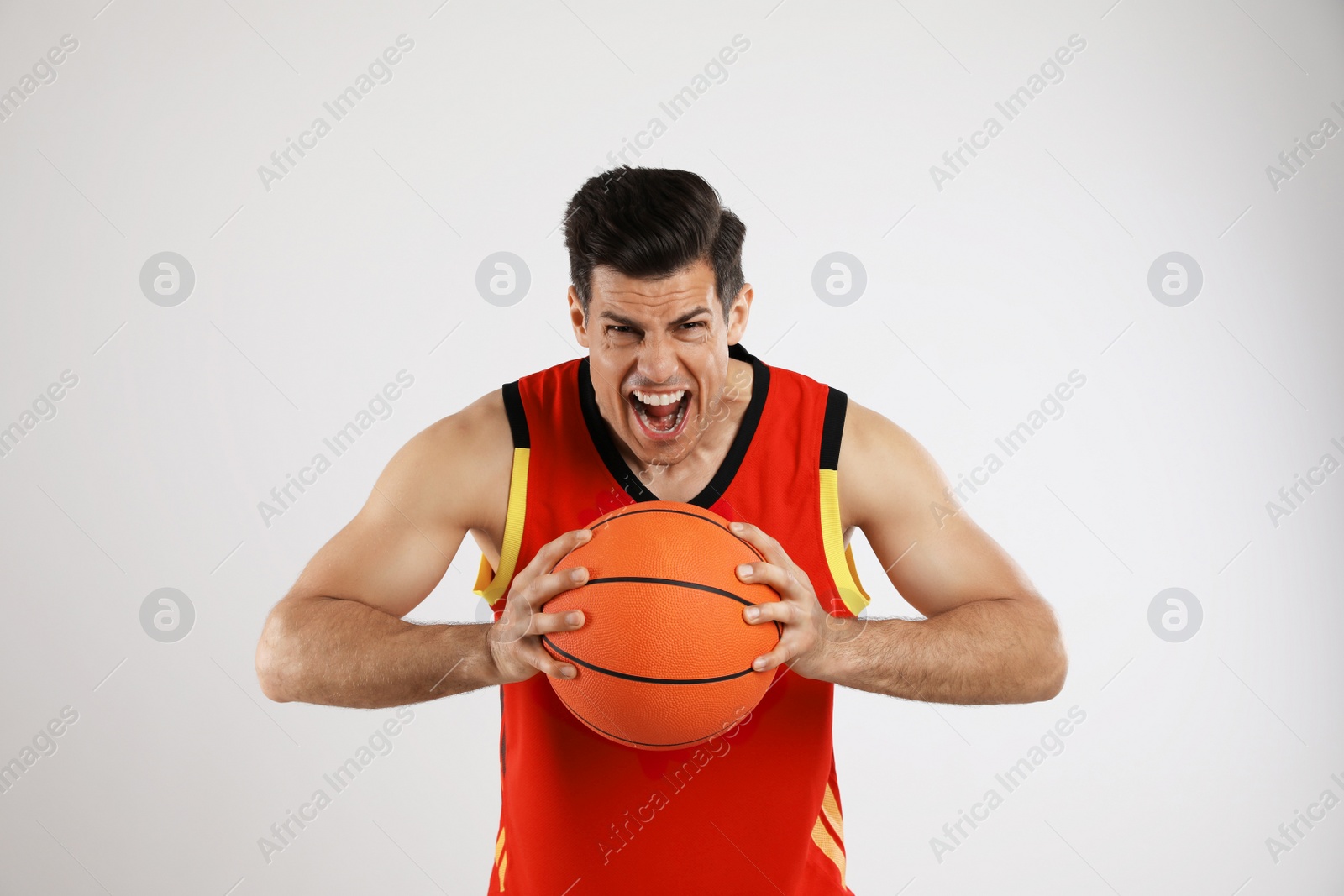 Photo of Basketball player with ball on grey background