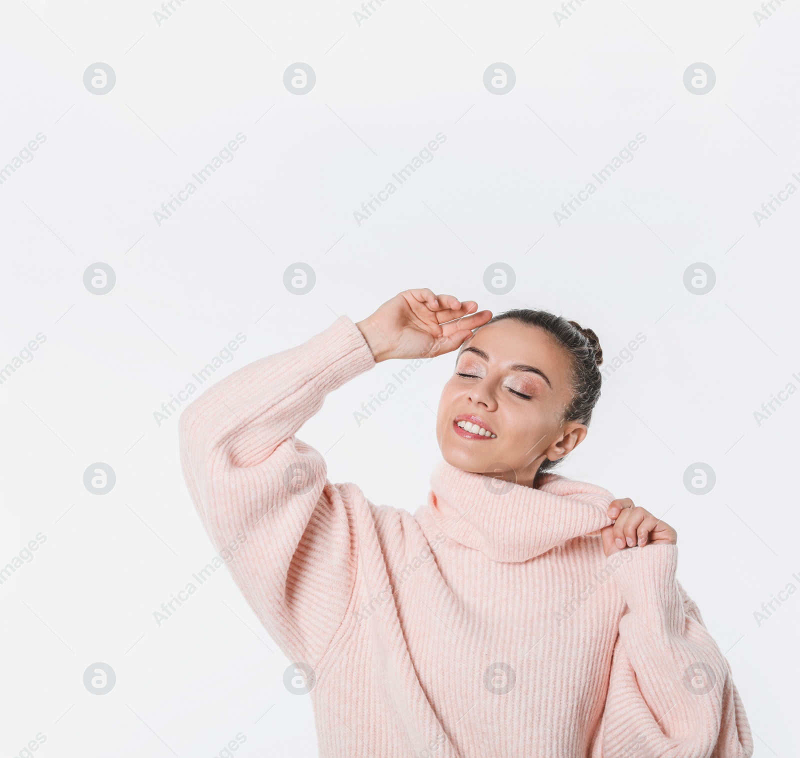 Photo of Young woman in stylish pink sweater on white background