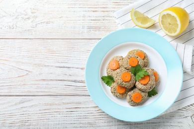 Photo of Flat lay composition with plate of traditional Passover (Pesach) gefilte fish on wooden background. Space for text