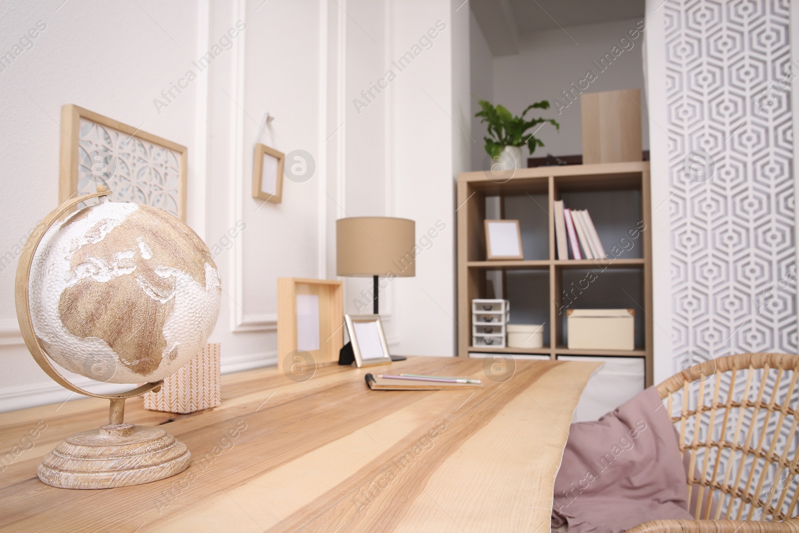 Photo of Wooden table with desk lamp in room. Interior design