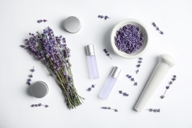 Composition with lavender flowers and natural cosmetic on white background, top view