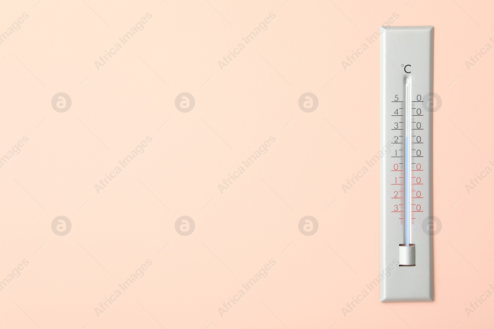 Photo of Weather thermometer on pink wall. Space for text