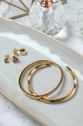 Photo of Elegant bracelets and earrings on white table