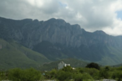Photo of Beautiful mountain and plants under grey sky, blurred view