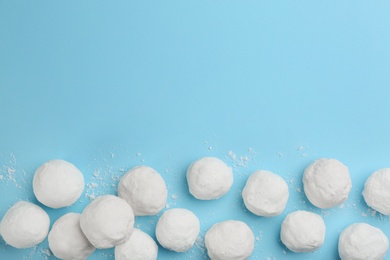 Snowballs on light blue background, flat lay. Space for text