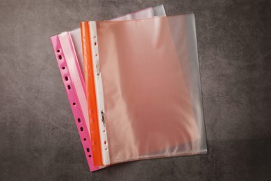 File folders with punched pockets on grey table, flat lay