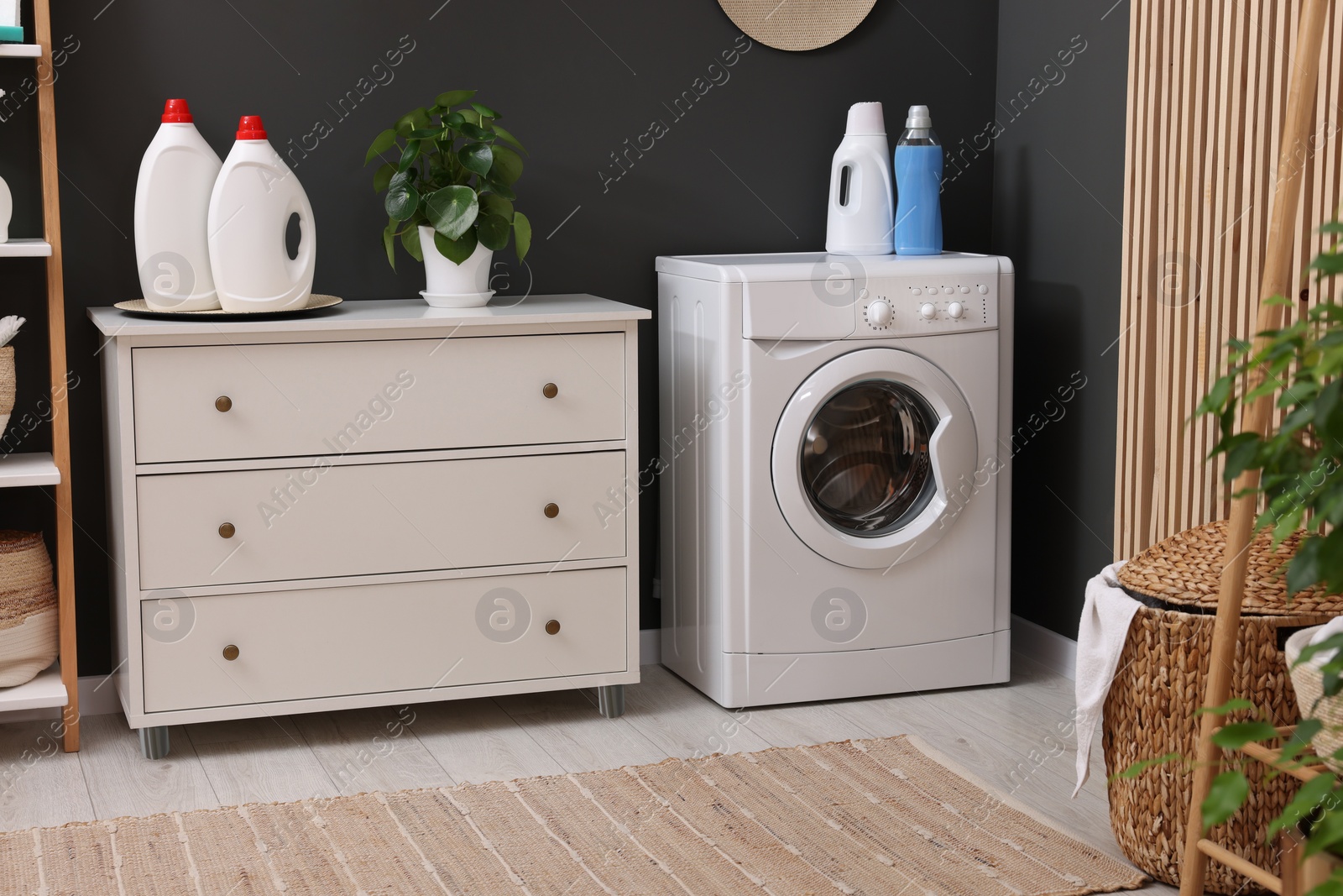 Photo of Laundry room interior with washing machine and furniture