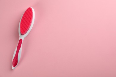 Photo of Pedicure tool with pumice stone on pink background, top view. Space for text