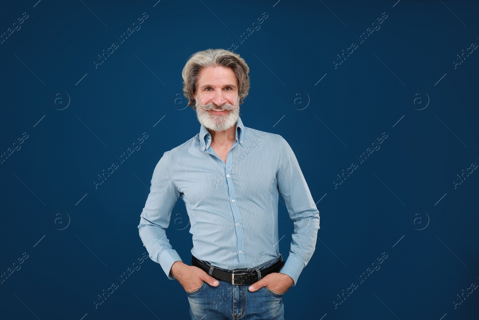 Photo of Portrait of handsome mature man on blue background