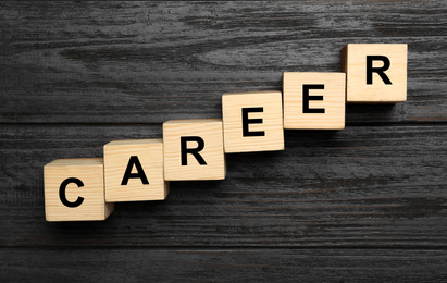 Photo of Cubes with word CAREER on wooden background, flat lay