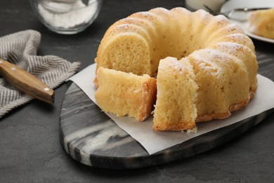 Delicious freshly baked sponge cake on black table