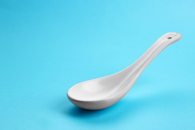 Photo of Clean empty miso spoon on blue background