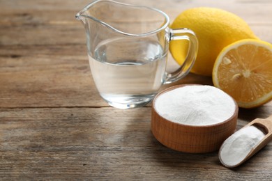 Photo of Composition with baking soda and cut lemons on wooden table