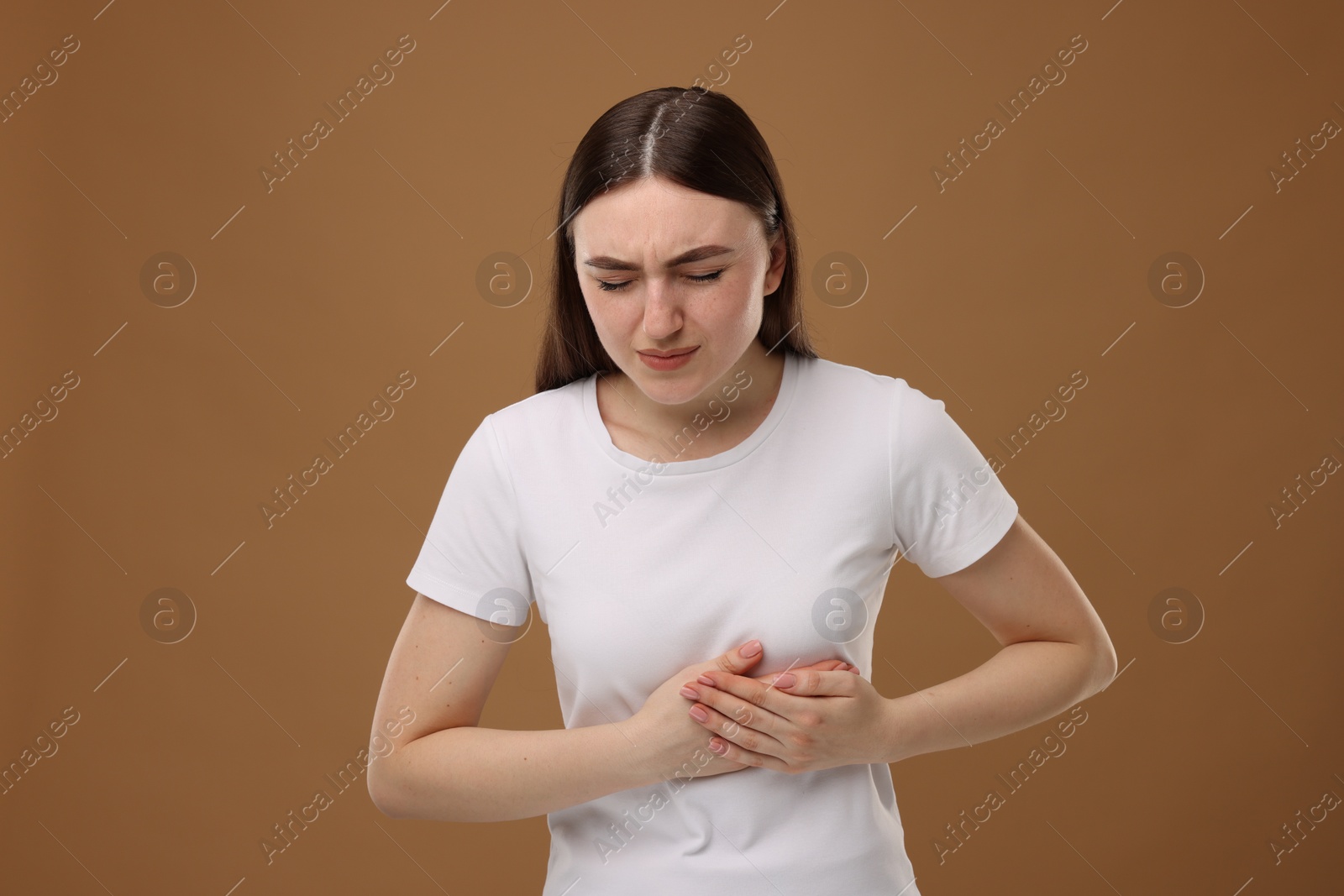 Photo of Woman having heart attack on brown background