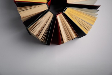 Photo of Hardcover books on grey background, flat lay