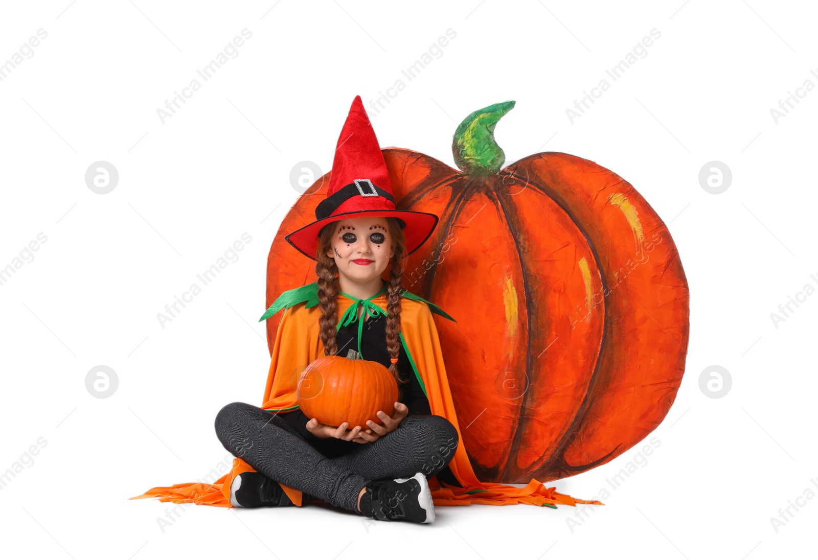 Photo of Cute little girl with pumpkin wearing Halloween costume on white background