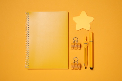 Photo of different school stationery on orange background, flat lay