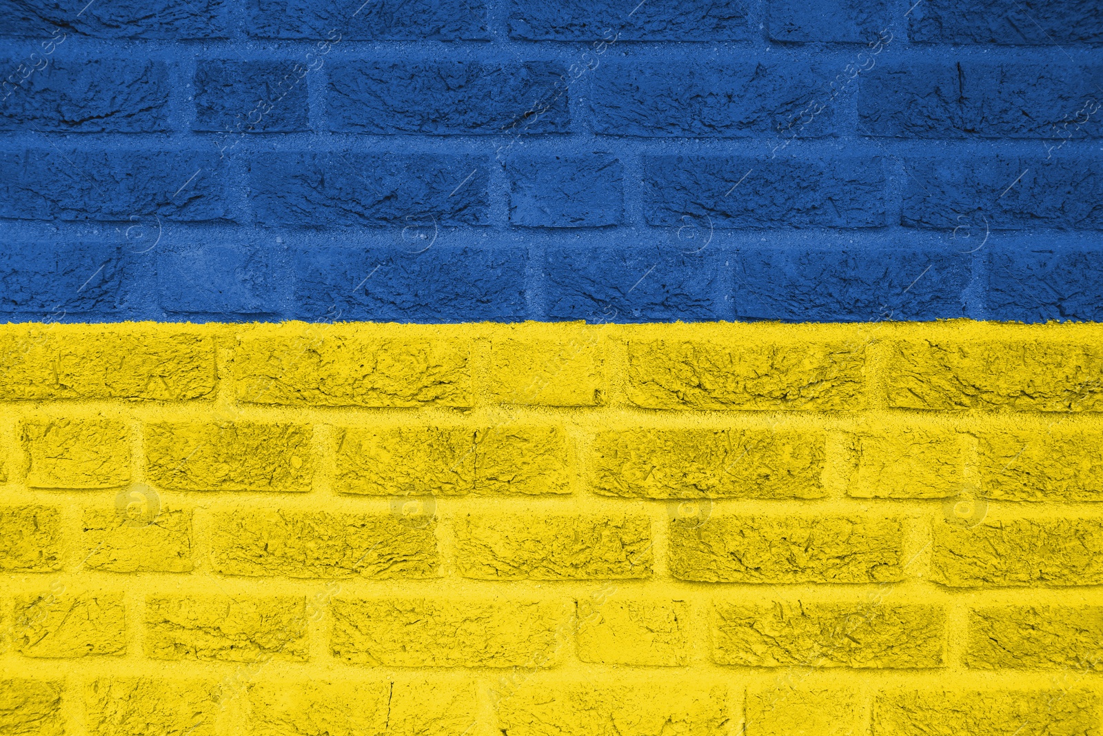 Image of National flag of Ukraine painted on brick wall