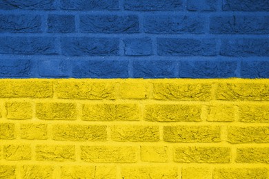 National flag of Ukraine painted on brick wall