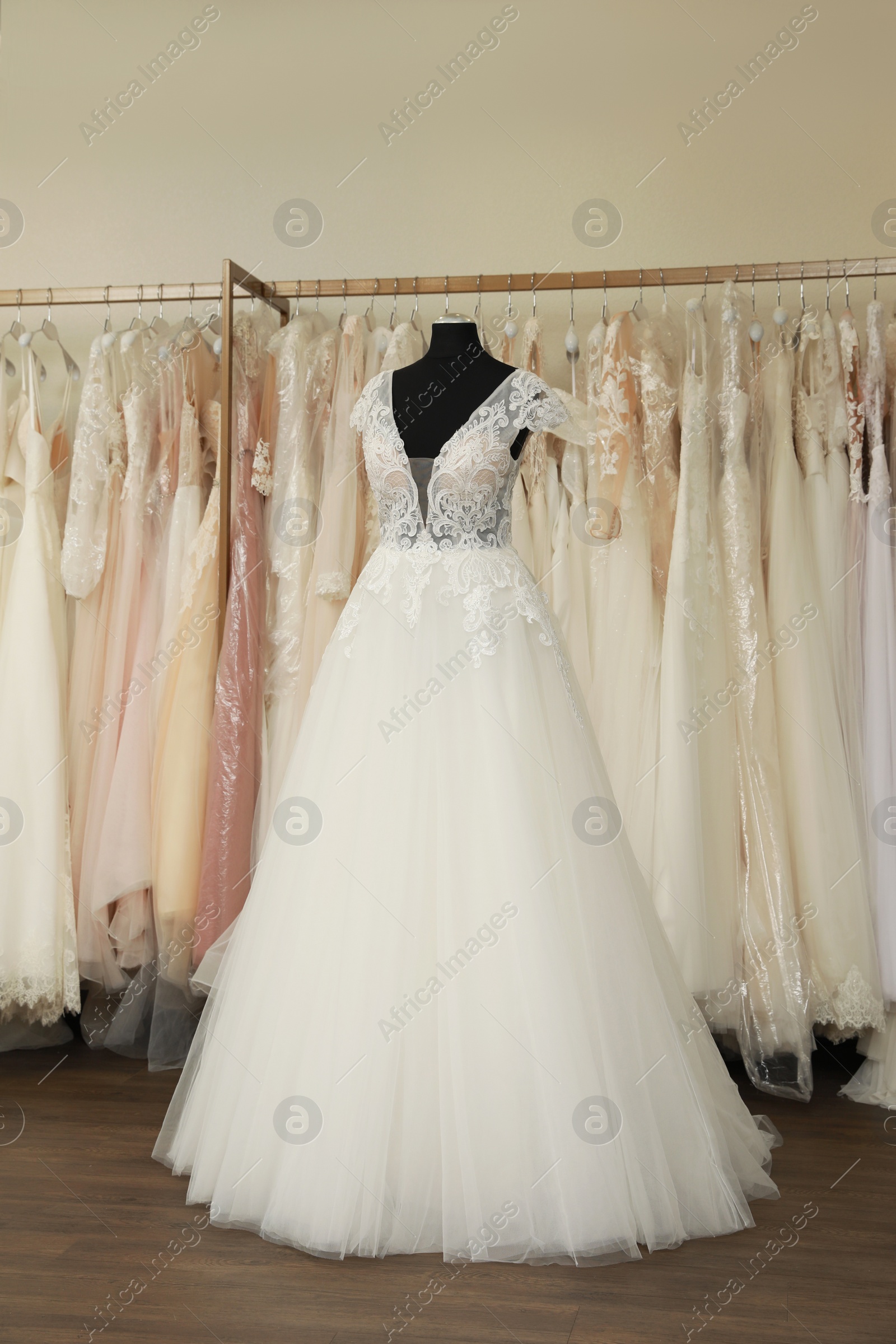 Photo of Beautiful wedding dress on mannequin in boutique