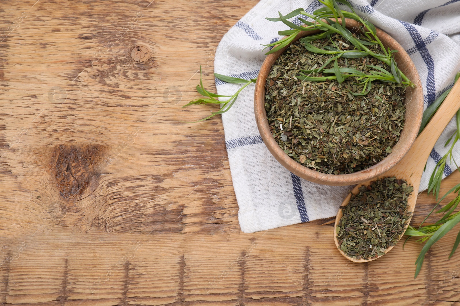 Photo of Dry and fresh tarragon on wooden table, flat lay. Space for text