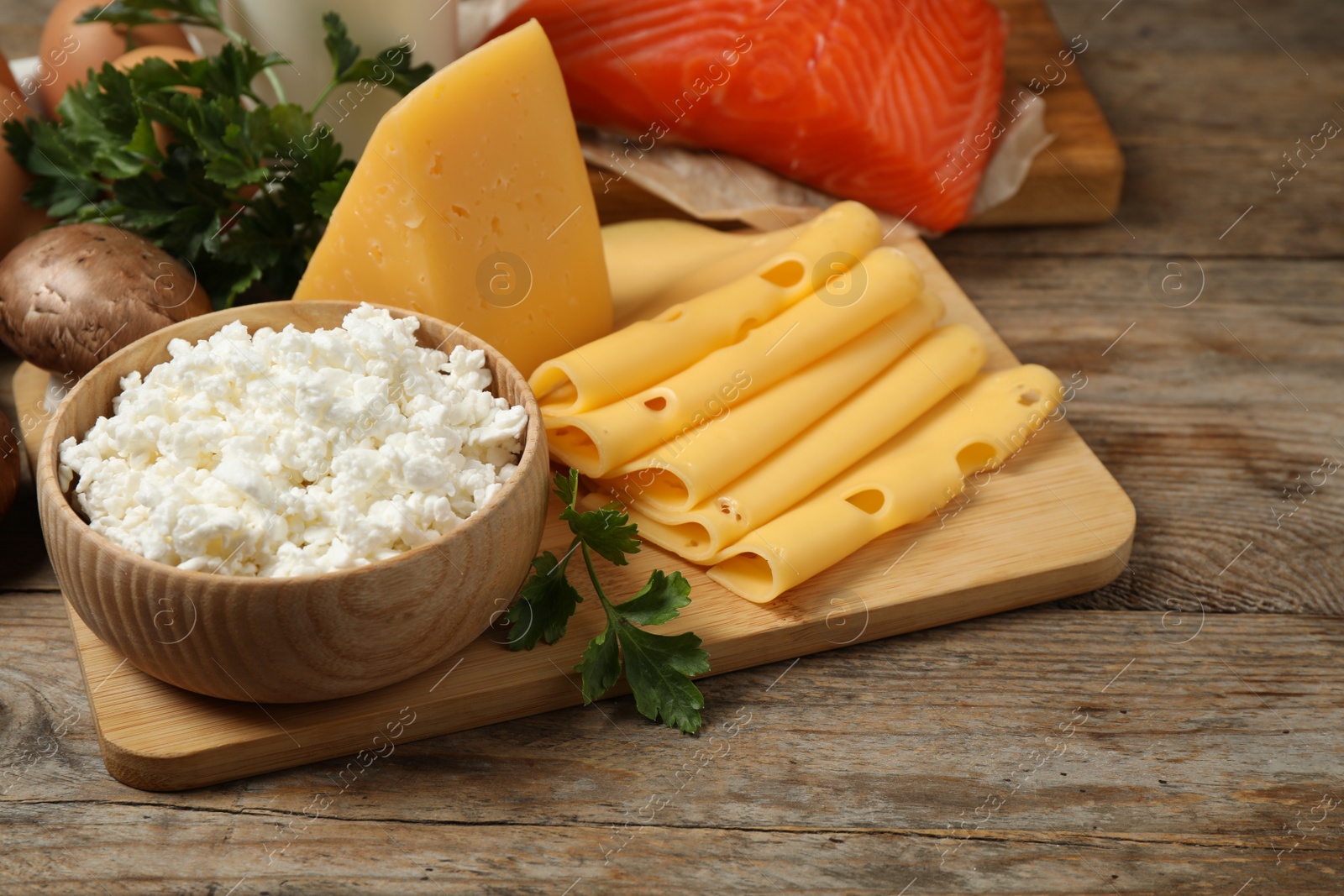 Photo of Fresh products rich in vitamin D on wooden table