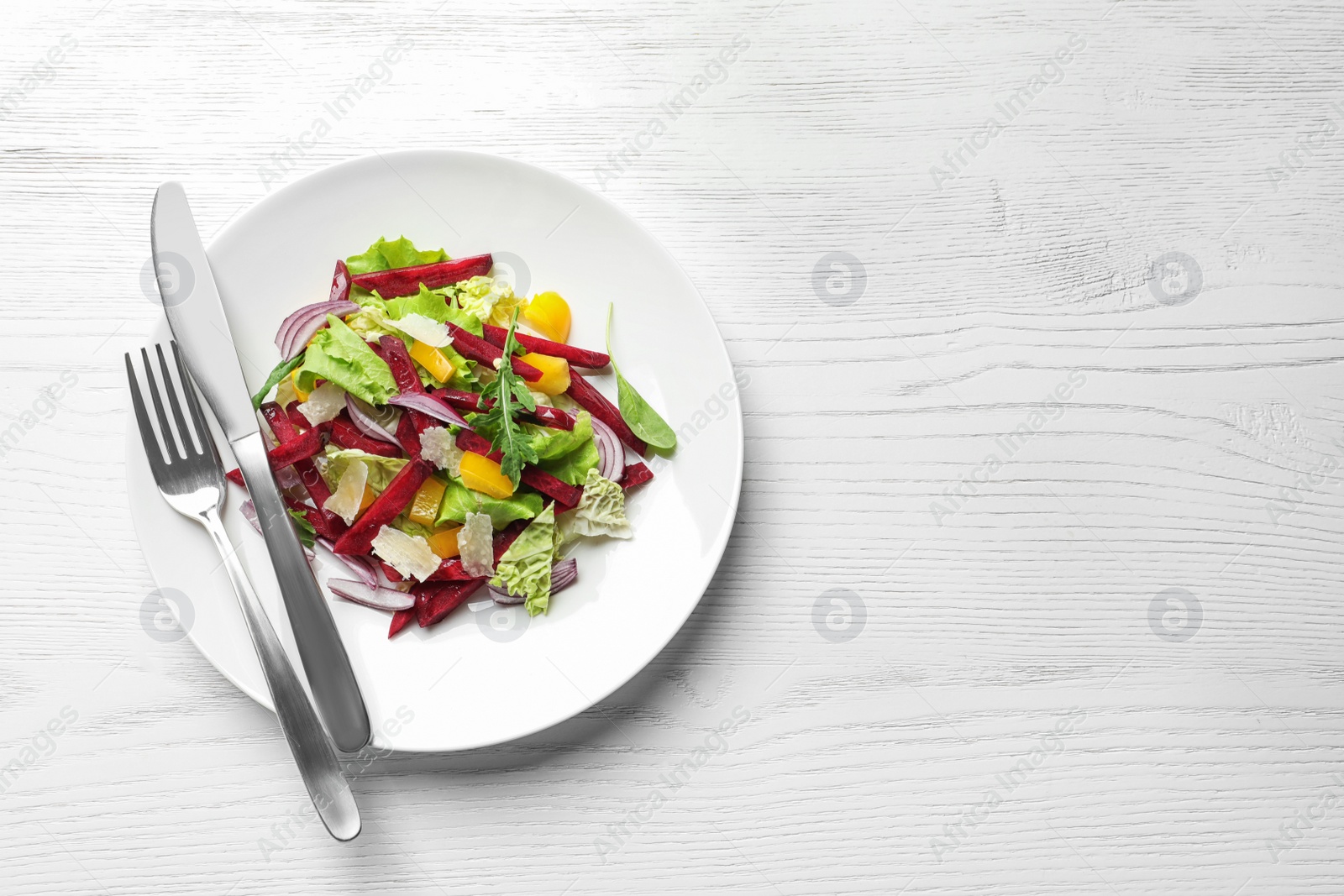 Photo of Plate with delicious beet salad on wooden background, top view