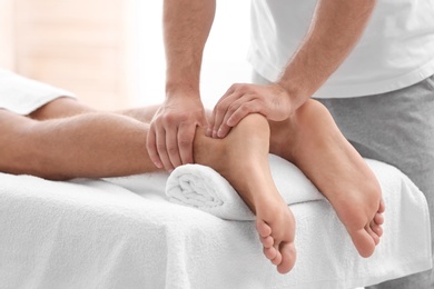 Young woman receiving massage in salon, closeup