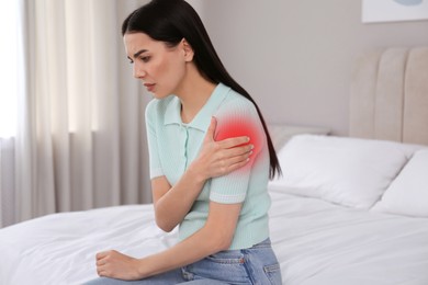 Image of Woman suffering from pain in shoulder at home