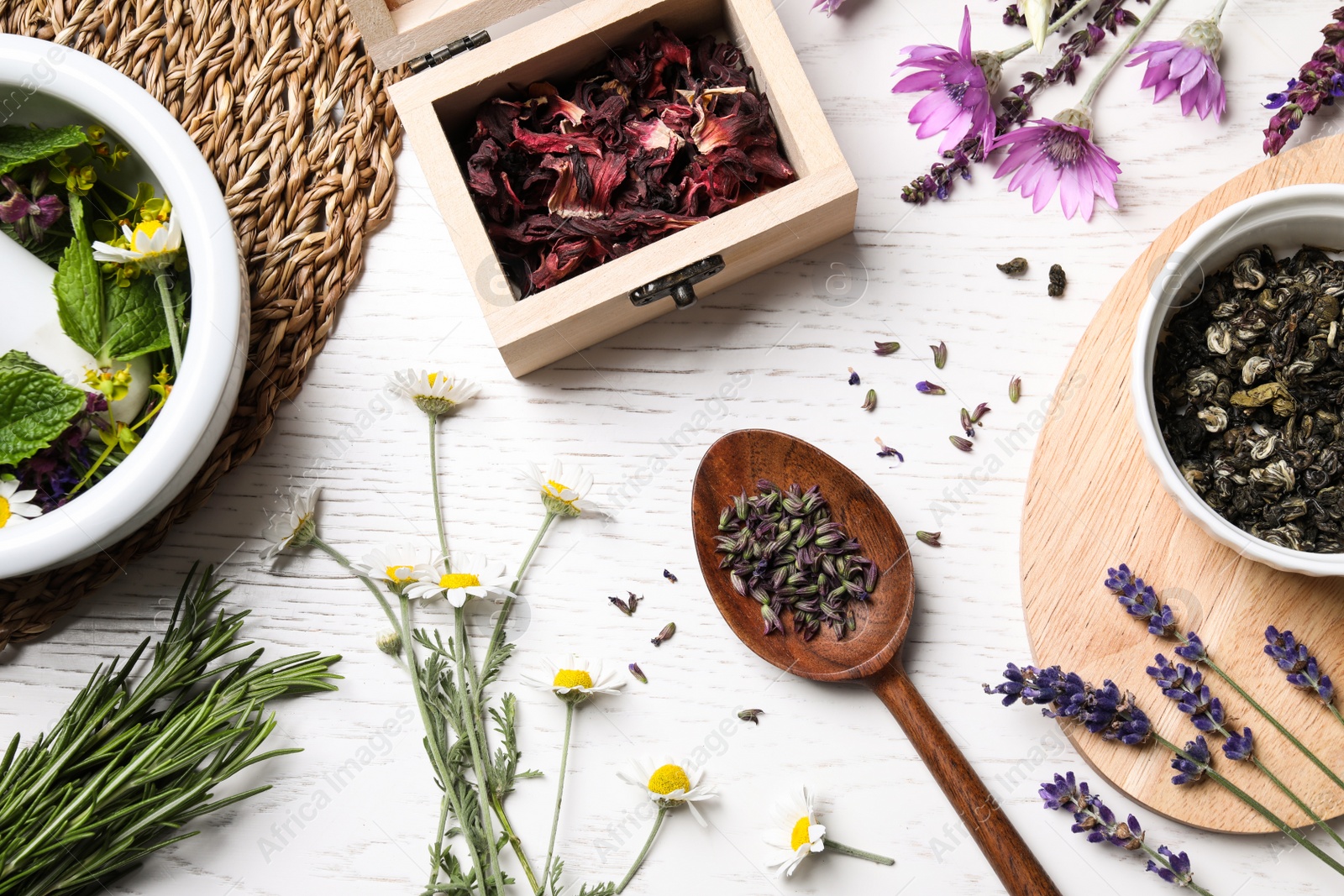 Photo of Flat lay composition with healing herbs on white wooden table